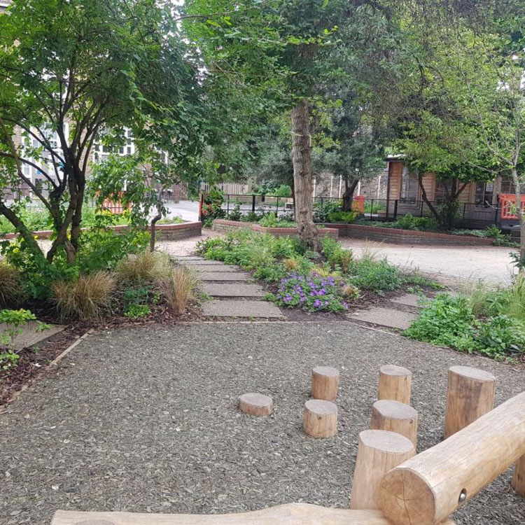 Play area stepping stones surrounded with trees & plants